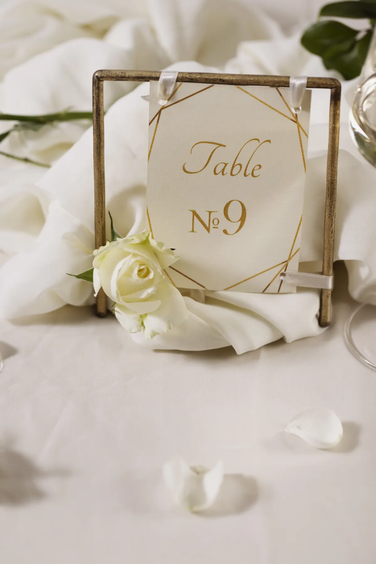 An elegant wedding table number surrounded by flowers